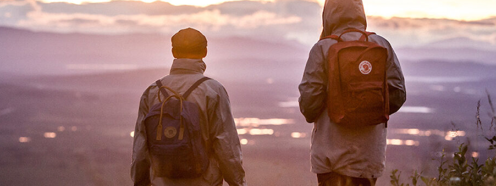 Two people on a mountain wearing Fjallraven Bags on their backs