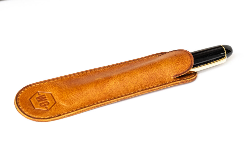 Write GEAR Leather Pen Sleeve with pen half way out the opening to show fit