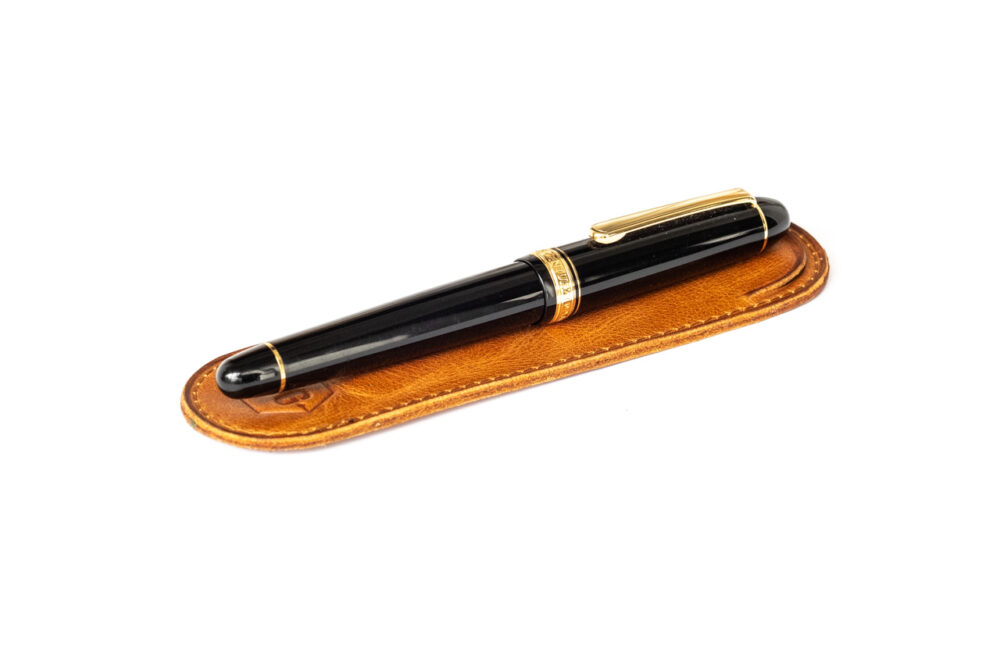 Write GEAR Leather Pen Sleeve with pen ontop to show size