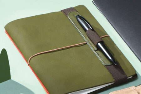 Endless Pen Loop Green on notebook with pen inside