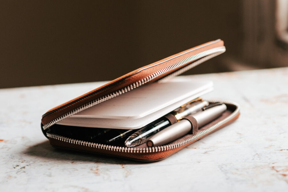 Endless Companion Leather Pen Pouch opening with view of pens and notebook