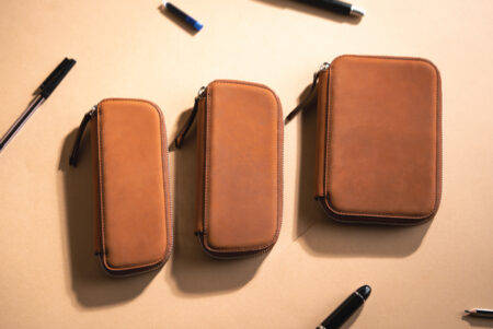 Endless Companion Leather Pen Pouch Series lifestyle image with pens scattered around it