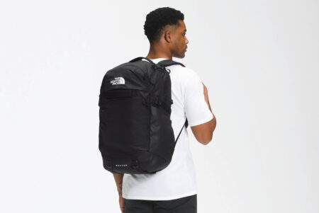 The North Face Router Backpack - Black on a man's back.