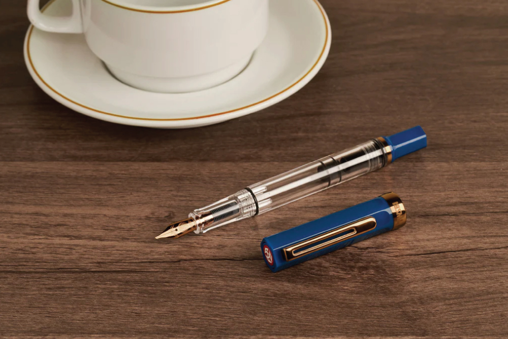 TWSBI ECO Fountain Pen - Indigo Blue with Bronze on coffee table