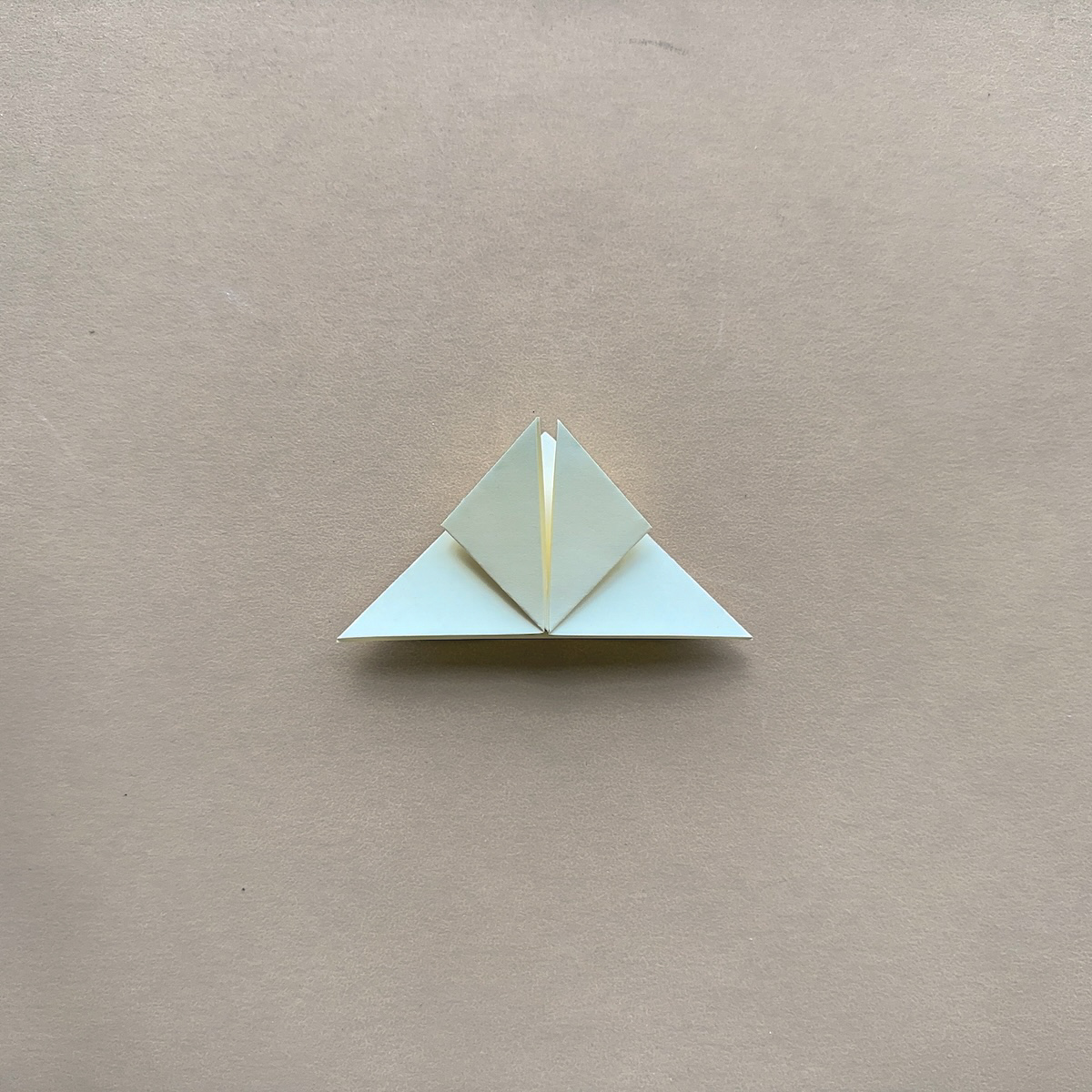 Origami paper folded on kraft brown background