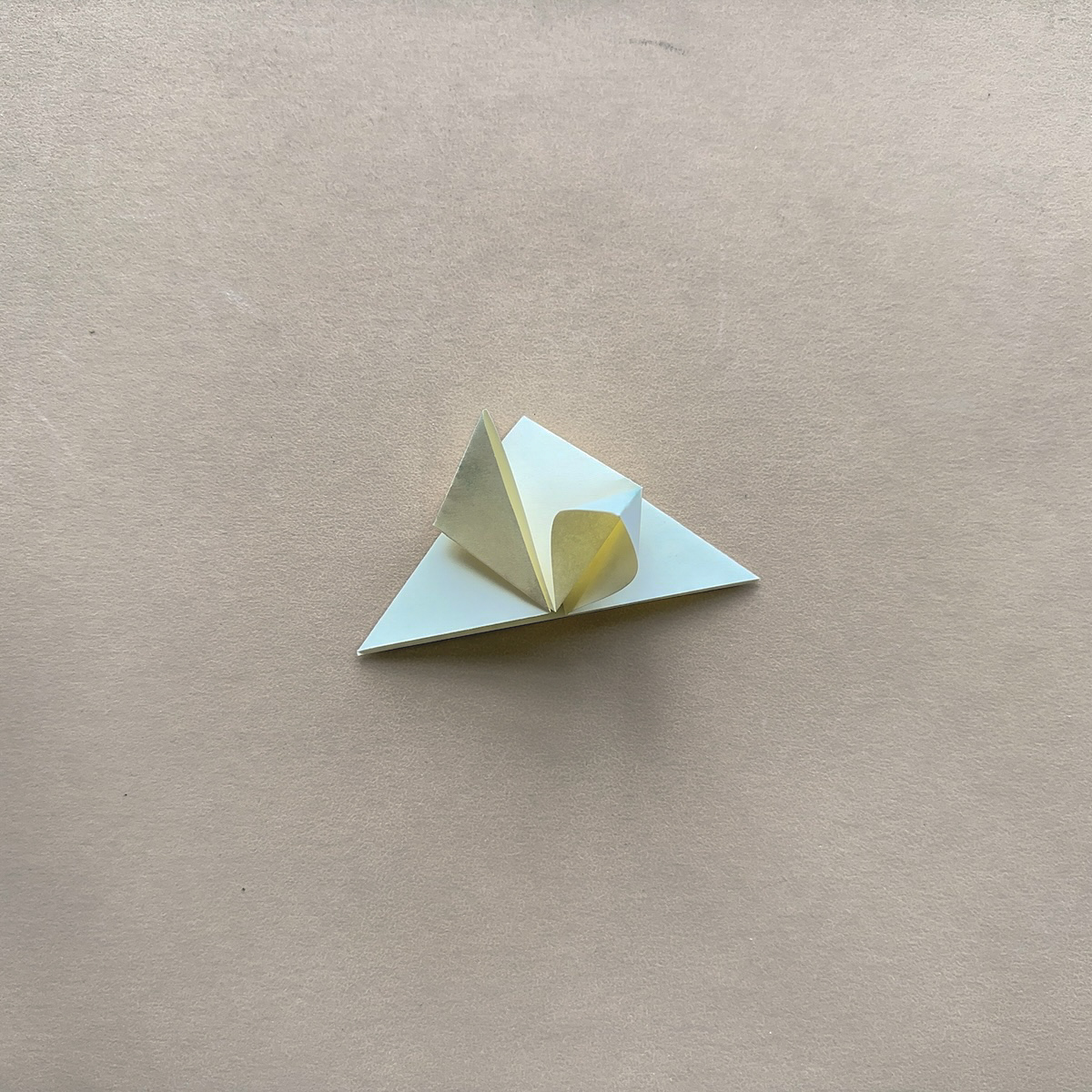 Origami paper folded on kraft brown background